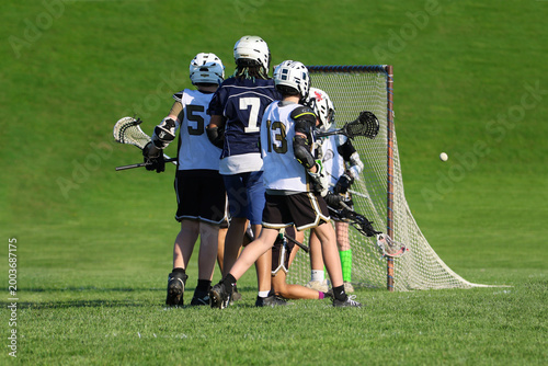 Young boys playing Lacrosse game