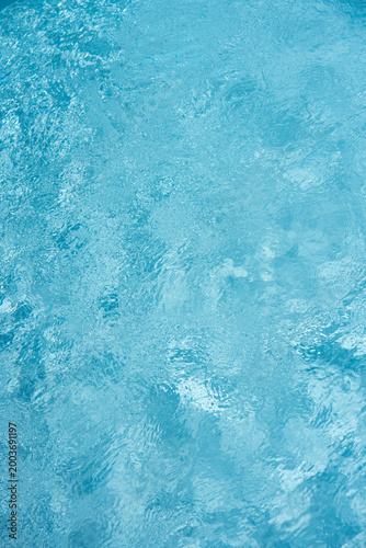 Light blue water texture background with soft ripples and bubbles