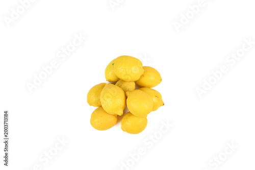 Pile of bright yellow lemon fruit on white background