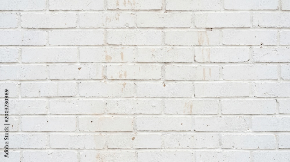 Fototapeta premium A close-up shot of a worn white brick wall with distressed texture