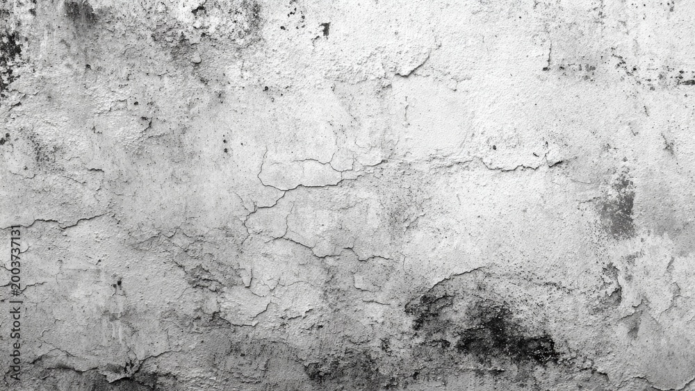 Obraz premium Textured cracked and peeling plaster surface with dark stains and imperfections