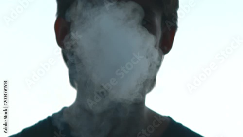 Cityscape Scene With Obscured Performer Immersed In Thick Fog And Dark Lighting Conditions . Media