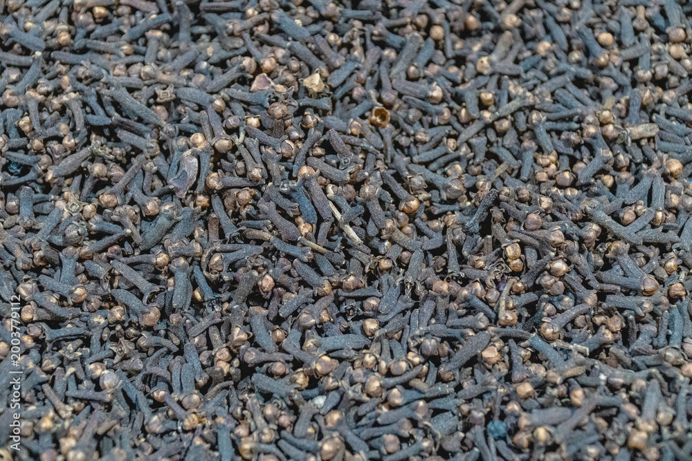 Fototapeta premium Dried clove spice texture with dark brown tones, detailed organic background ideal for food ingredient, herbal, and culinary concepts