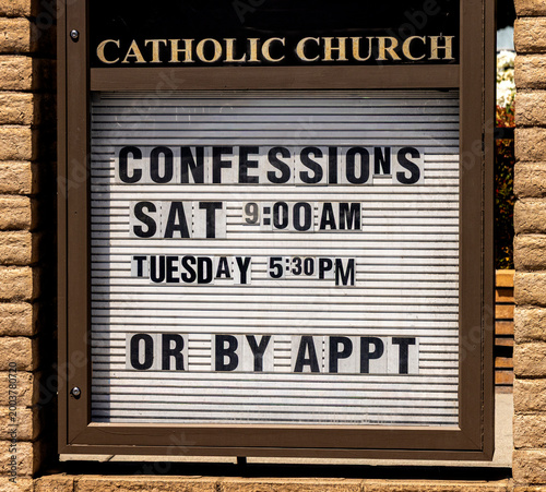 Photos A sign at a Catholic church indicating that confessions can be made on certain d