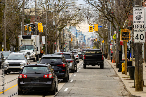 Photography Morning rush hour traffic on urban commercial street with vehicles, traffic sign