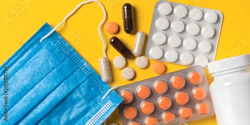 Medical Mask with Pills and Capsules on Bright Background Representing Healthcare Protection Treatment Prevention and Pharmaceutical Concept