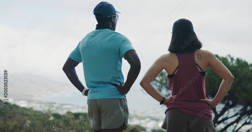 Naklejka premium Fitness, back and couple with view of city for exercise break, nature appreciation and relax. Active relationship, people and sightseeing outdoor for cardio rest, ocean scenery and marathon recovery