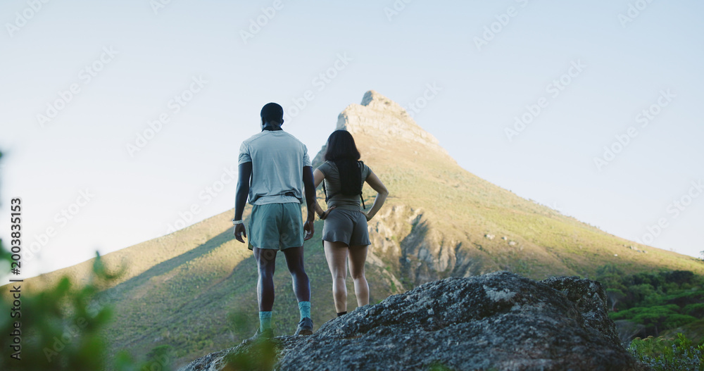 Obraz premium Back, couple and hiking for fitness on cliff for travel, adventure and outdoor view on holiday. Space, people and trekking mountain for sightseeing, explore nature and fresh air on getaway vacation