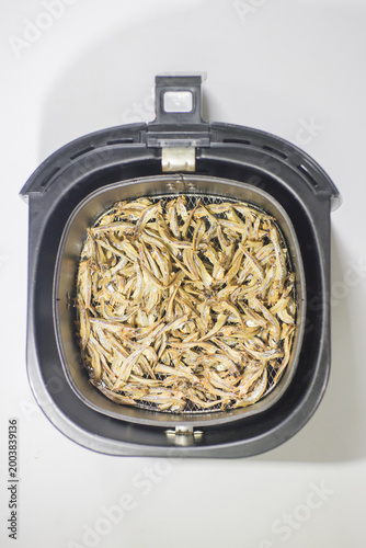 Dish with small sprats in the sink, close-up