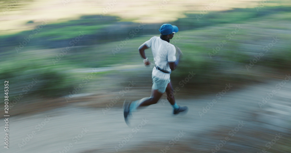 Obraz premium Exercise, black man and running in woods with motion blur, body health and cardio endurance workout. Person, outdoor and fast runner in forest for fitness, training and practice sprint with speed