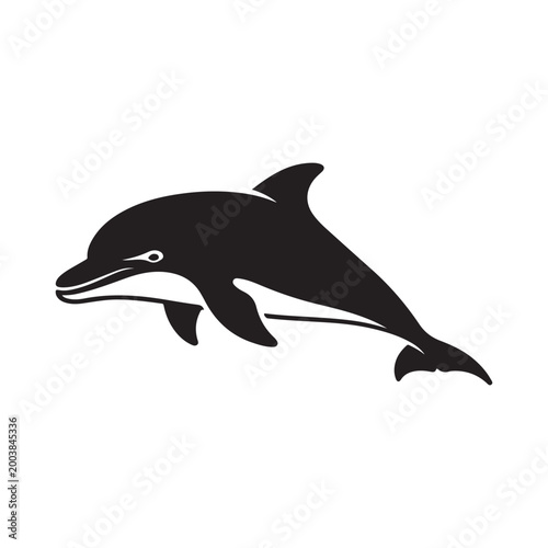 A sleek black silhouette of a dolphin leaping gracefully from the water