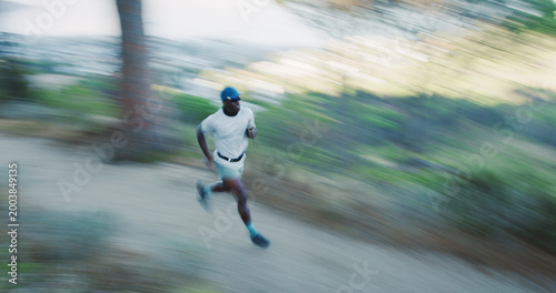 Foto Fitness, black man and running in woods with motion blur, body health and cardio endurance workout
