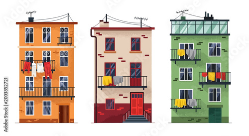 Three colorful mid-rise buildings with hanging laundry and vivid facades along an urban street.