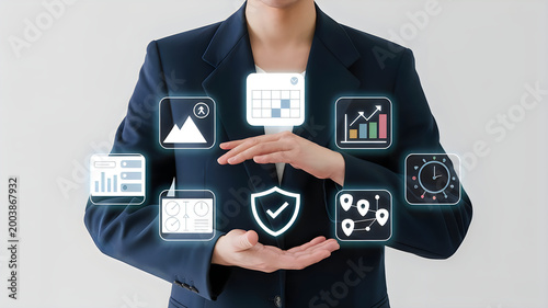 Business professional in dark suit protecting glowing digital icons representing calendar security schedules and data charts between cupped hands.