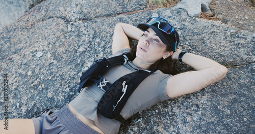 Fotografía Tired, woman and relax for fitness on rocks from exercise, intense training and recovery