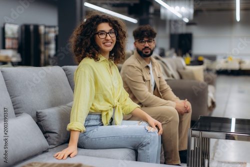 Tableau sur toile Couple choosing buying sofa in furniture store showroom