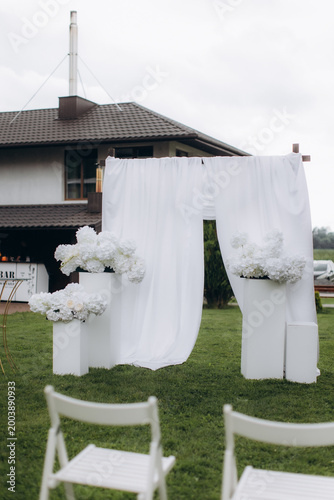 Photography Outdoor wedding ceremony arch with white flowers