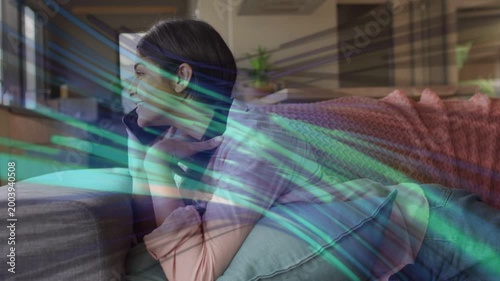 Teen girl lying on sofa chatting on phone, call starting teal tech streaks sweeping overlaying her