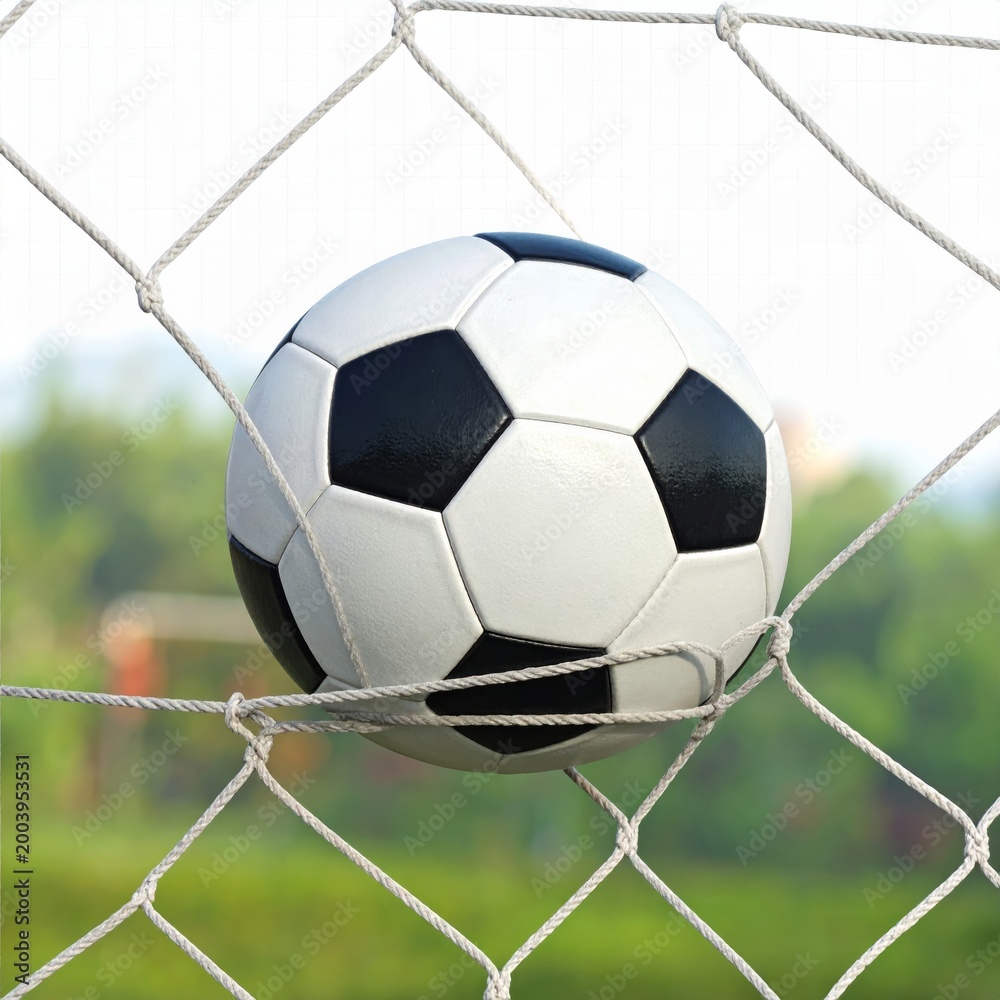 Naklejka premium Soccer Ball Moving into Goal Net Dynamic Sports Action Scene with Motion and Energy