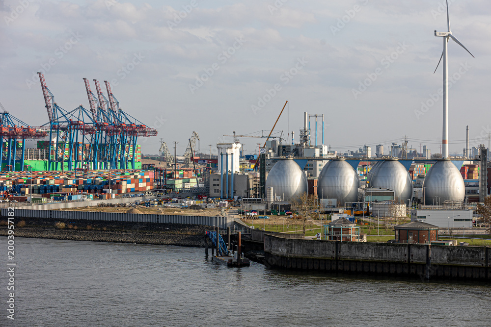 Fototapeta premium Hamburg port industry and logistics with wind turbine