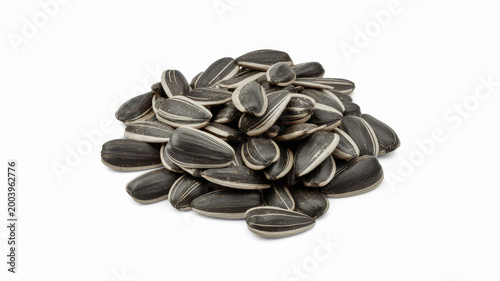 Heap of raw black sunflower seeds with white stripes isolated on a white background surface