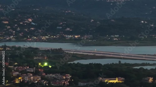 Aerial View of Corfu International Airport Runway at Dusk with Airplane Over the Lagoon, Greece