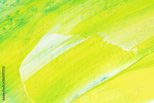 Abstract lime green painted background with diagonal brush strokes