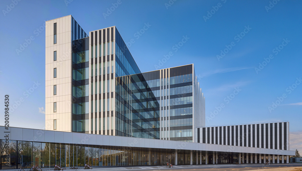 Fototapeta premium Modern Business Architecture with Glass Facade and Blue Sky