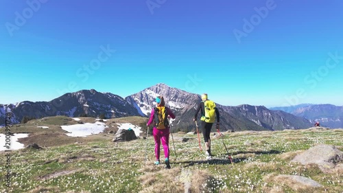 Rear View of Couple Hiking Toward Mountain Peaks