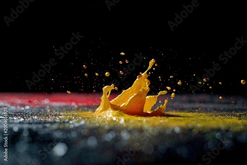 Bright Paint Merges On Shadowed Background. Dynamic Spray Of Colors Freezes In Energetic Macro Shot