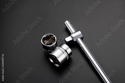 Bilde på lerret Professional chrome socket wrench set with T handle bar and hexagonal sockets on black background