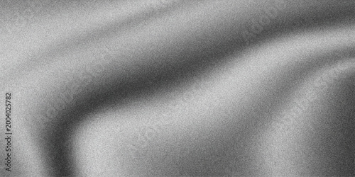 A dark brushed metal texture with a stainless steel pattern featuring a shiny silver metallic surface and a black fabric material backdrop for a sleek grey aluminum design