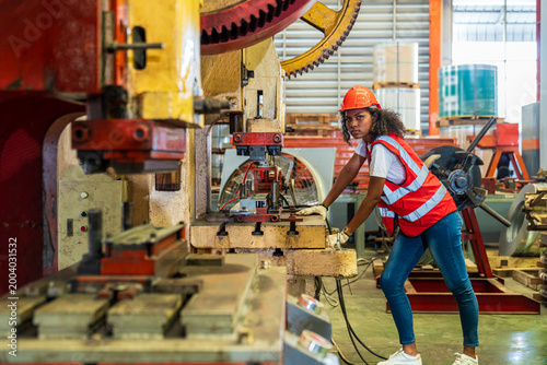 A female worker employed in a metal sheet factory.