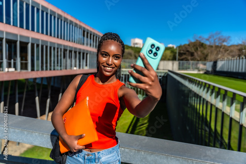 Young black student making selfie on university campus
