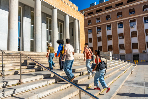Quadro em tela Diverse students walking up stairs on university campus