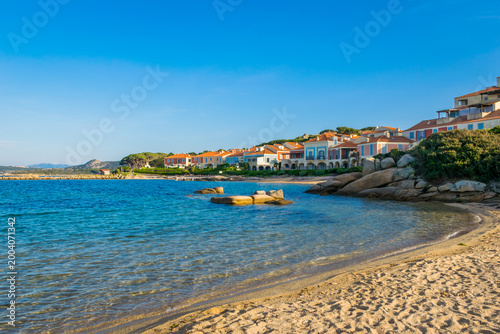Panoramic view of colorful Porto Faro vacation houses with sandy beach during sunset, Palau, Sardinia Island, Italy