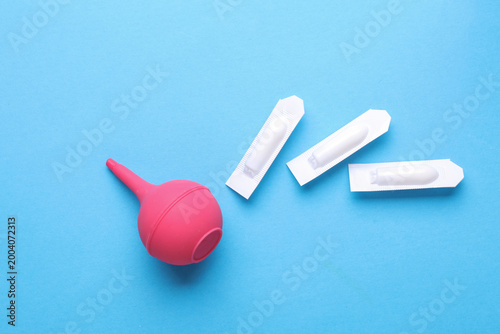 Konstfotografi Rectal suppositories and enema on blue background
