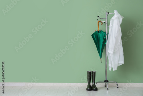 Clothes rack with raincoat,...