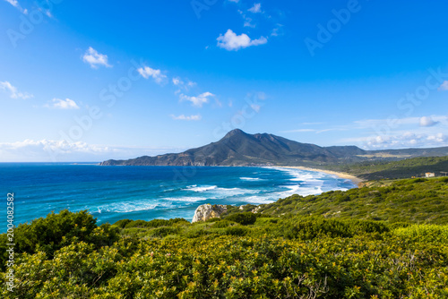 Photos Panoramic view of Dido beach in Portixeddu Bay with Punta Su Guardianu hill in t