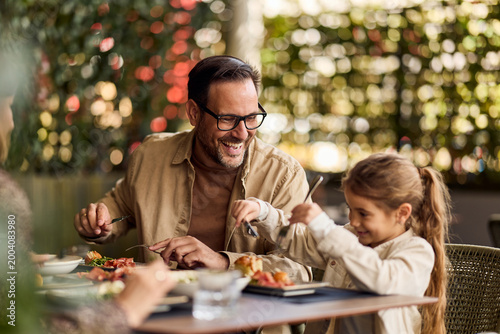 Father and Daughter Laughing Together Over Lunch at Outdoor Cafe Family Meal and Bonding