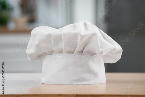 Chef's hat on wooden table ...