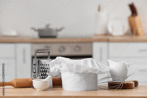 Chef's hat and utensils on ...