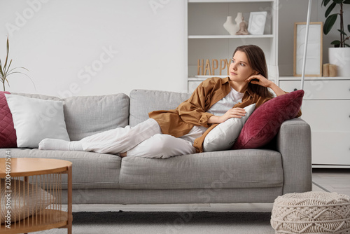 Beautiful young woman lying...