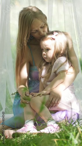 Mother and daughter hugging in park - picnic and birthday