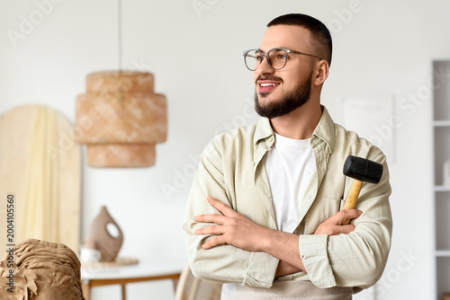 Young male sculptor with ha...