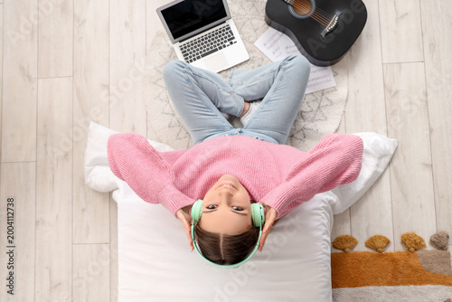 Young girl with headphones,...