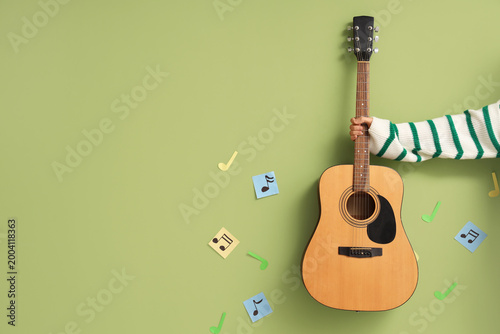 Hand with guitar and paper ...
