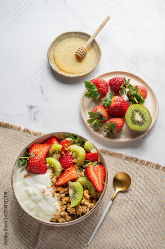 Healthy yogurt bowl with granola and fresh berries for clean eating diet