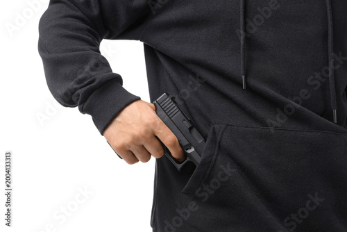 Foto Man taking gun out from his hoodie pocket on white background