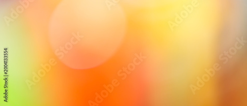 Fotografia Vibrant orange and yellow bokeh abstract background with green accent and glowin